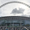 A distinctive arch stands above the structure of Wembley Stadium in London, England