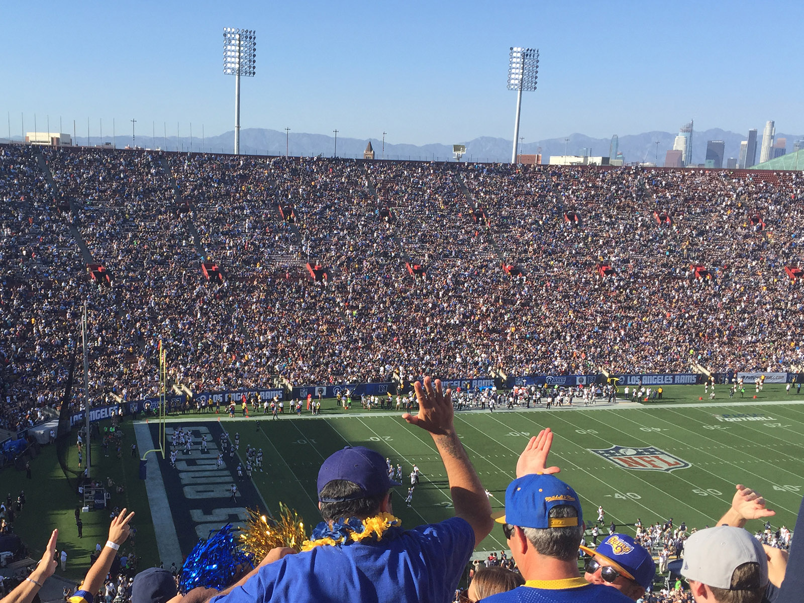 Fans celebrate in the stands at the Los Angeles Memorial Coliseum during a Rams football game