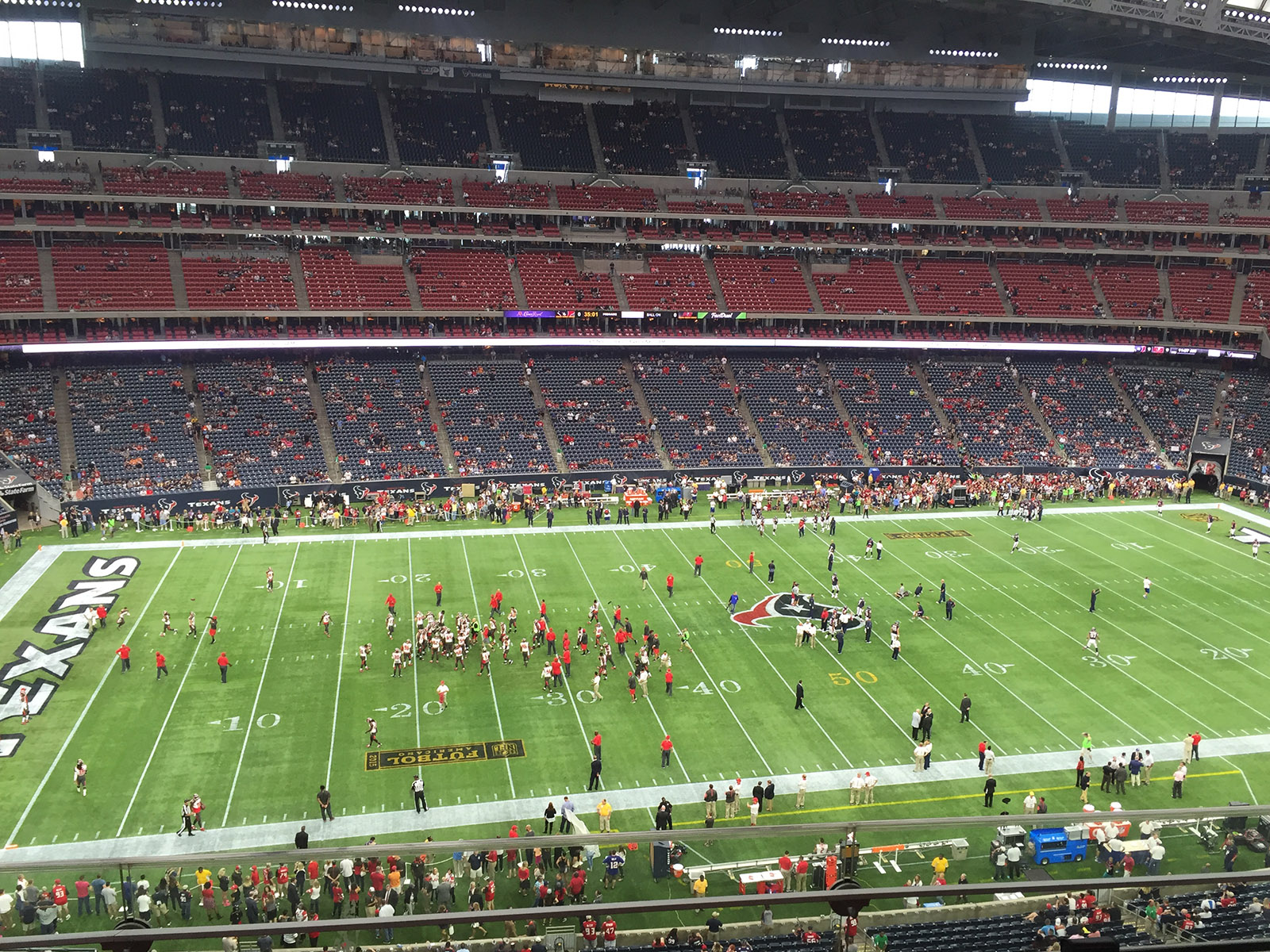 Players meet on the field at the end of a Texans football game at Reliant Stadium in Houston, Texas