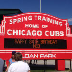 Fans gather in front of a marquee at Sloan Park in Mesa, Arizona, during a Chicago Cubs spring training game