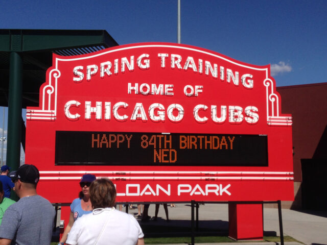 Fans gather in front of a marquee at Sloan Park in Mesa, Arizona, during a Chicago Cubs spring training game