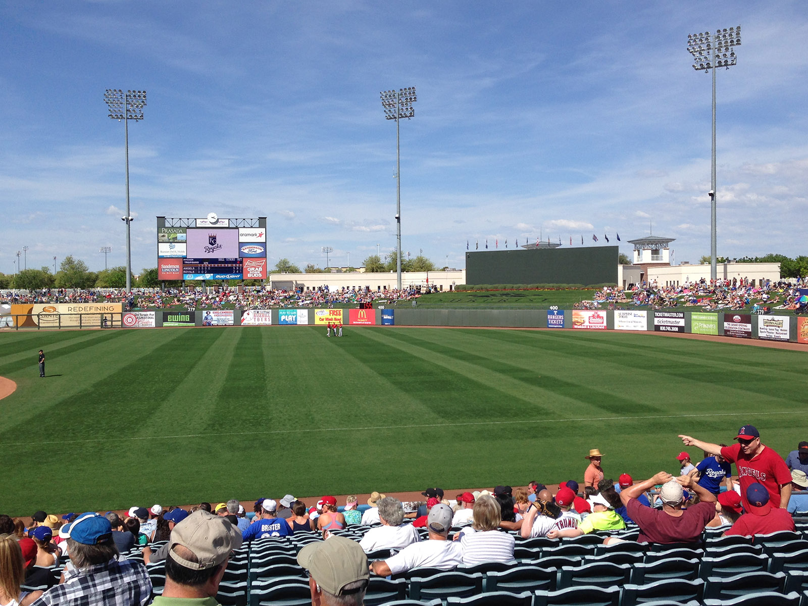 Fans watch a spring training baseball game from the stands at Surprise Stadium in Surprise, Arizona